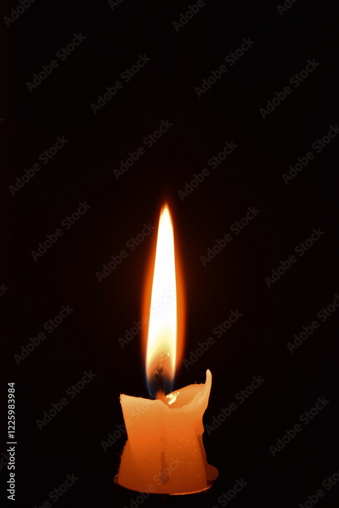 Burning candle on black background Burning candle on black background