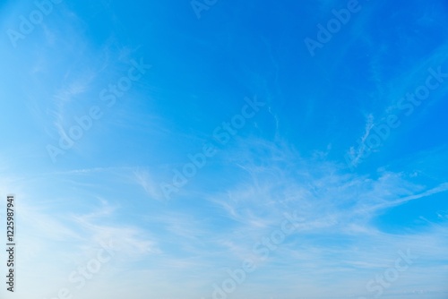 Fototapeta Naklejka Na Ścianę i Meble -  Delicate feathery cirrus clouds drift across the expanse of the sky, creating a serene and tranquil scene. Perfect for backgrounds, weather illustrations, and nature-themed projects.