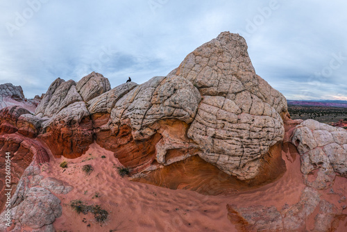 Unrecognizable person standing atop rocks in White Pocket photo