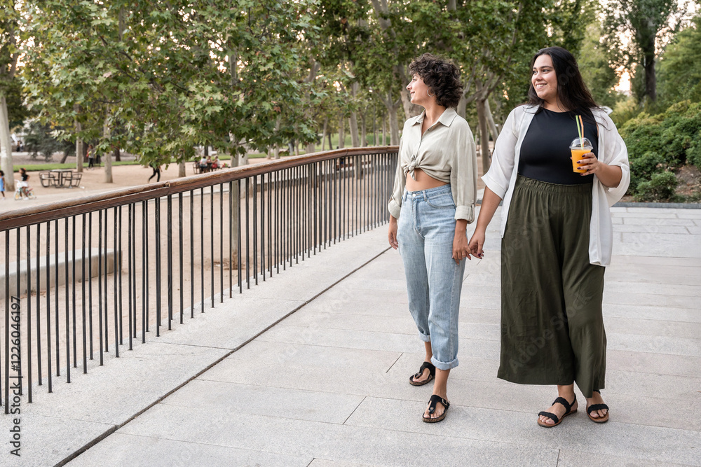 Lesbian couple enjoying a stroll in the park together Lesbian couple enjoying a stroll in the park together