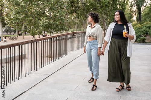 Lesbian couple enjoying a stroll in the park together photo