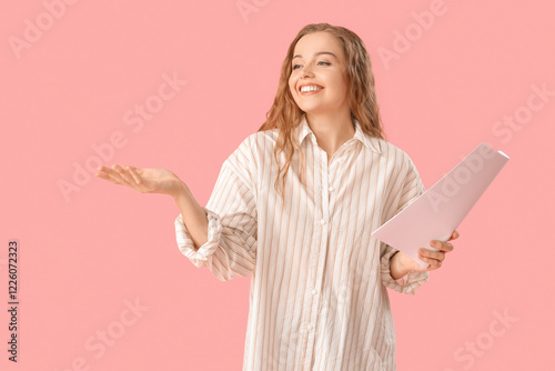 Beautiful actress with film script on pink background