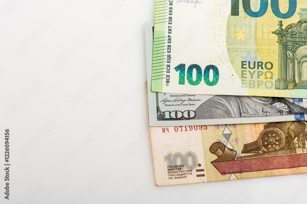 Different money in 100 euro, 100 dollar and Russian 100 ruble banknotes as background. Top view. Different money in 100 euro, 100 dollar and Russian 100 ruble banknotes as background. Top view.