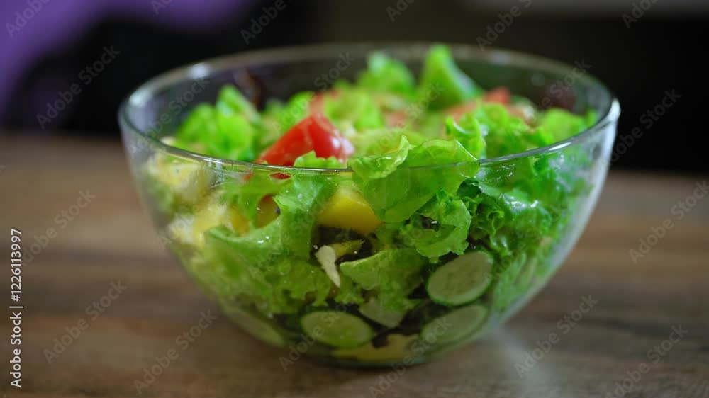 A vibrant, healthy dish full of nutrients, perfect for any table. raw food gourmet drizzling vitamins pouring. Fresh Mediterranean Greek salad with feta, crisp veggies, and olive oil in a glass bowl. A vibrant, healthy dish full of nutrients, perfect for any table. raw food gourmet drizzling vitamins pouring. Fresh Mediterranean Greek salad with feta, crisp veggies, and olive oil in a glass bowl.