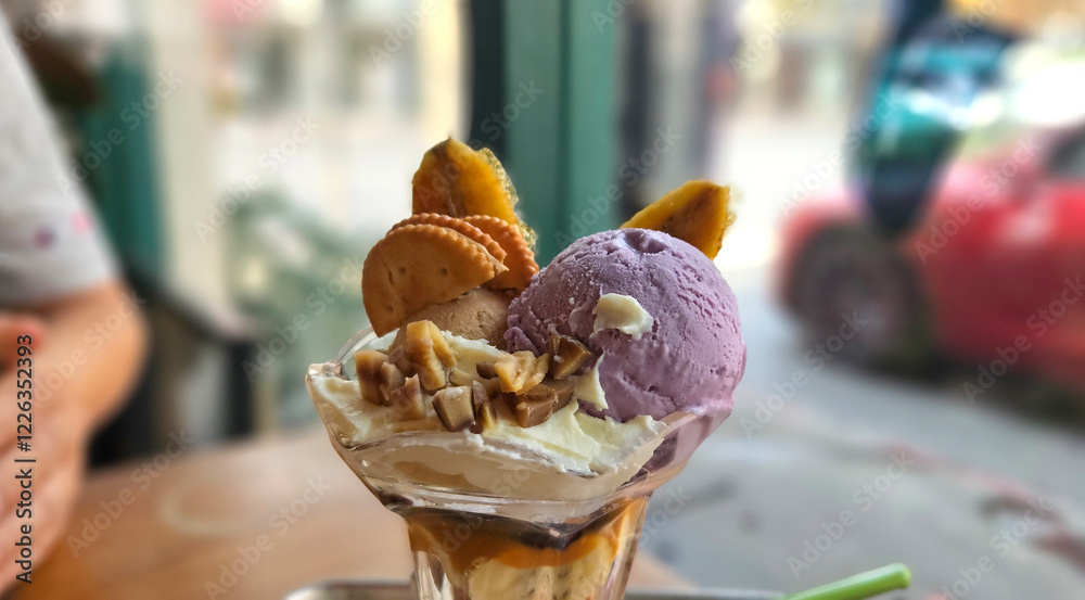 Thai style sweet potato homemade ice cream serving with wiped cream, chestnut, cracker, and banana