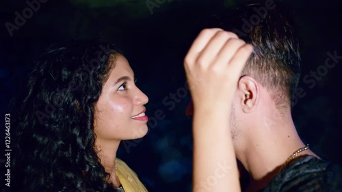 Couple playfully holding each other by dark