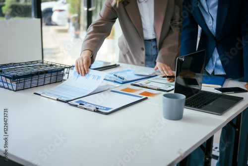 Konstfotografi An African American businesswoman and a Caucasian woman work at analyzing market