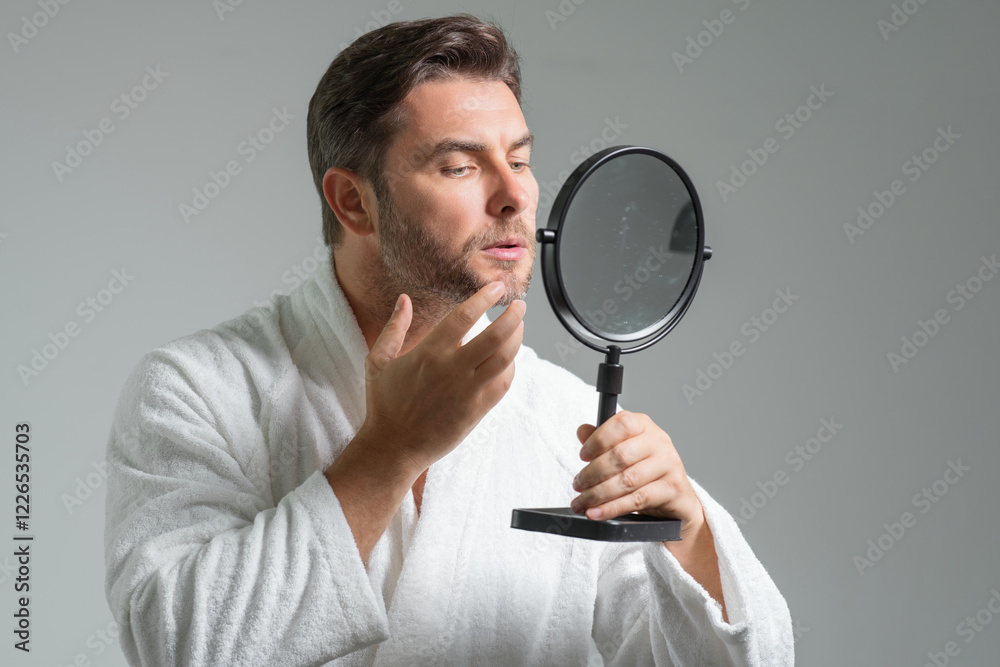 Close-up portrait of perfect brunet man touching chin and skin. Handsome man touching face in gray studio isolated background. Perfect skin. Man cosmetic, skin treatment. Hygiene skin care male face. Close-up portrait of perfect brunet man touching chin and skin. Handsome man touching face in gray studio isolated background. Perfect skin. Man cosmetic, skin treatment. Hygiene skin care male face.
