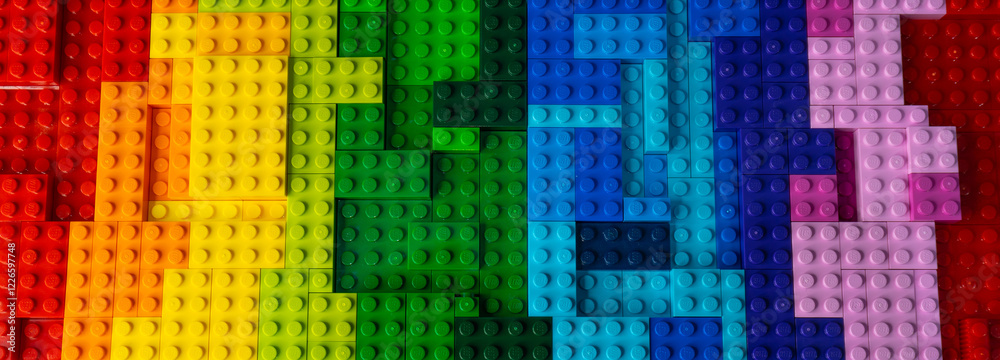 Obraz premium Arad,Romania - February 2, 2025: Multicolored rainbow colorful gradient background Lego Classic structure pieces. Modern bright backdrop design