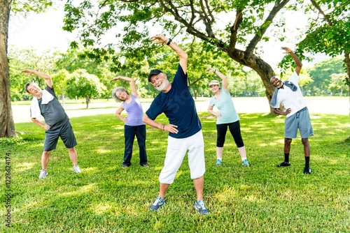 Group of diverse healthy seniors exercising outdoors. Healthy elderly men and women stretching in a park. Active seniors enjoying exercise in the park. Diverse group of senior people exercise in park.
