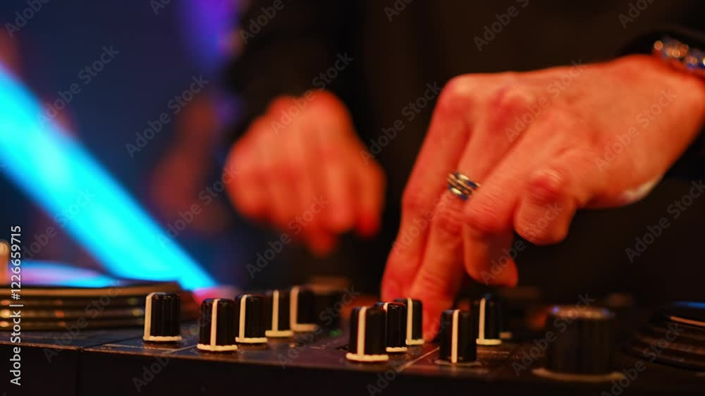 Hands of a DJ with a mixing console at a party. music for the disco. Professional musician.