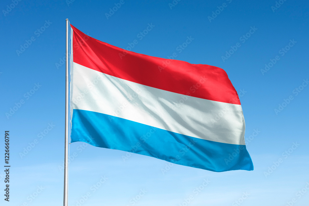 Waving Luxembourg flag, national symbol, blue sky Waving Luxembourg flag, national symbol, blue sky