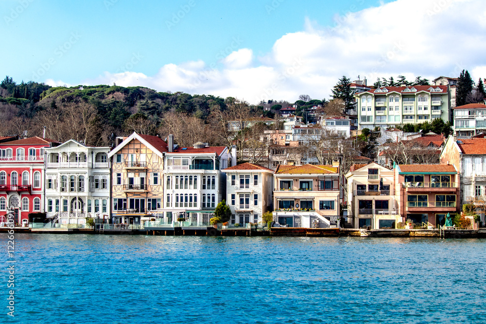 Obraz premium Blue sea and colorful mansions of Yeniköy. Historical buildings and mansions. Touristic destination of Istanbul. Architecture idea concept.