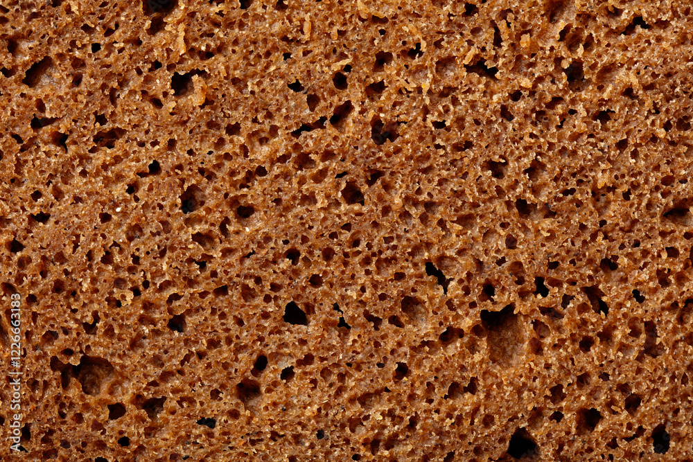 The image is of a brown bread with holes in it