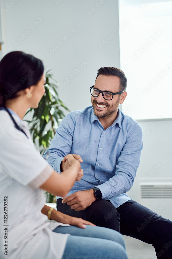 Friendly Handshake Between Professional Man and Woman in Modern Setting Friendly Handshake Between Professional Man and Woman in Modern Setting
