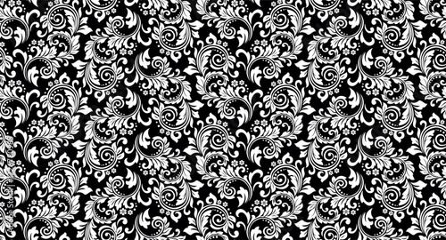 Wallpaper in the style of Baroque. Seamless vector background. White and black floral ornament. Graphic pattern for fabric, wallpaper, packaging. Ornate Damask flower ornament.
