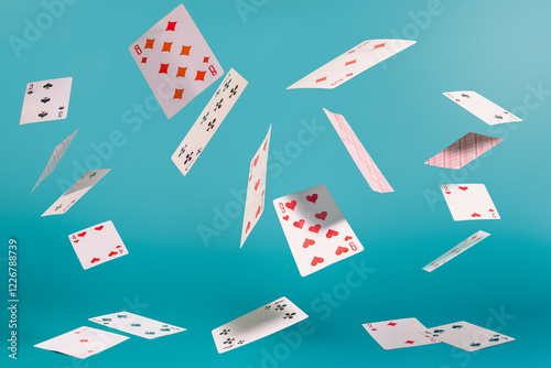 Bild auf Leinwand flying playing cards on a turquoise background