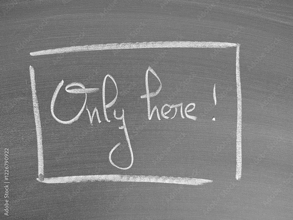 Fototapeta premium Only here message written on a chalkboard in handwritten script