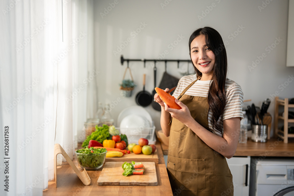 Portrait of Asian woman cooking green healthy salad in kitchen at home. Portrait of Asian woman cooking green healthy salad in kitchen at home.