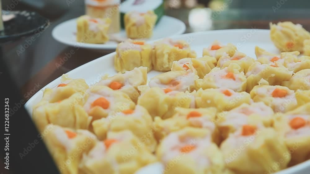 A group of people lined up to scoop up the food in the buffet line. Focusing on the hands of everyone who was scooping the food. A group of people lined up to scoop up the food in the buffet line. Focusing on the hands of everyone who was scooping the food.