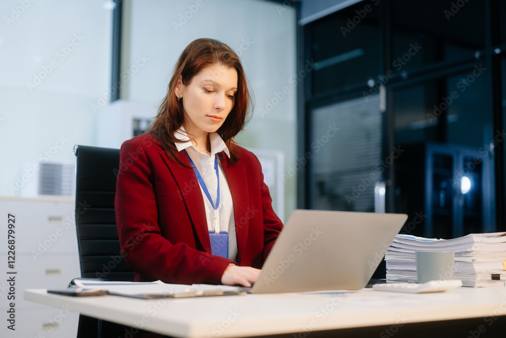 Confident businesswoman working on a laptop at a sleek office desk, showcasing professionalism, productivity Confident businesswoman working on a laptop at a sleek office desk, showcasing professionalism, productivity