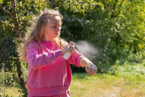 Young woman using insect sprays disease prevention. Protection against mosquito bite during summertime. Safety skin treatment outdoors