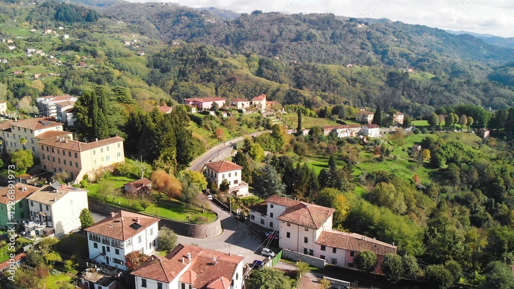 Fototapeta premium Aerial view of Barga, Garfagnana, showcasing the picturesque Italian village on a sunny day