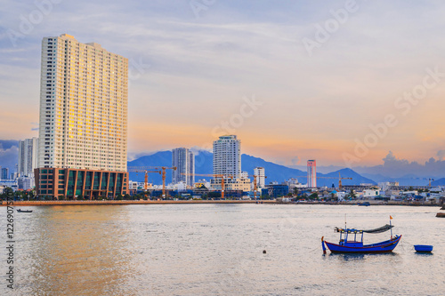 View of the Kei River with fishing boats against the backdrop of Urban view in north district of Nha Trang city, Vietnam. photo