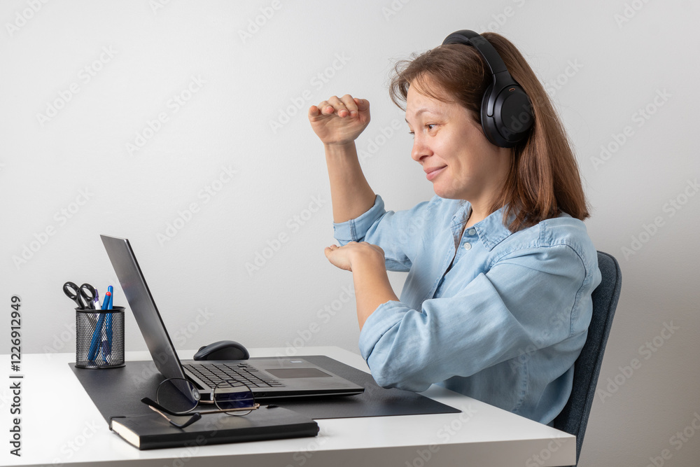 Cheerful freelance professional woman wearing big headphones talking on online chat meeting using laptop, speaking on video conference call, smiling, enjoying work online communication Cheerful freelance professional woman wearing big headphones talking on online chat meeting using laptop, speaking on video conference call, smiling, enjoying work online communication