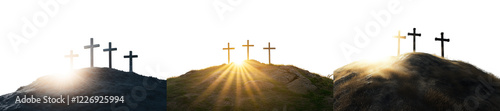 Three Crosses Illuminated by Sunrays on a Hill Against a White Background