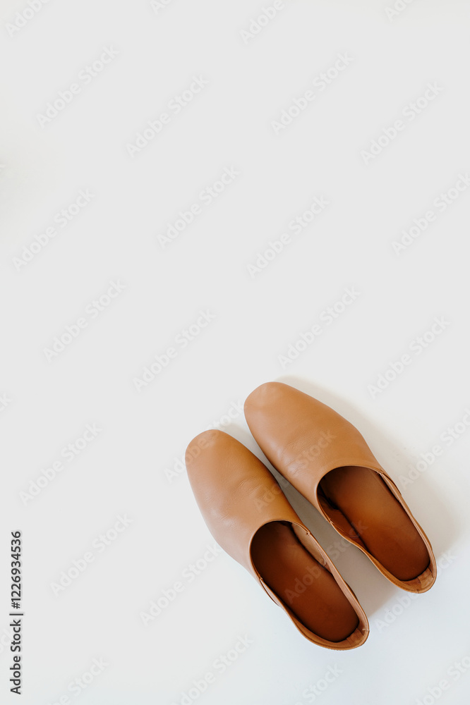 Modern Aesthetic with Brown Leather Shoes. Fashionable Footwear Arrangement on Clean White Background Modern Aesthetic with Brown Leather Shoes. Fashionable Footwear Arrangement on Clean White Background