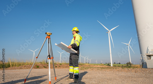 Wallpaper Mural Engineer wearing uniform inspection and survey work in wind turbine farms rotation to generate electricity energy. Maintenance engineer working in wind turbine farm at sunset. Torontodigital.ca