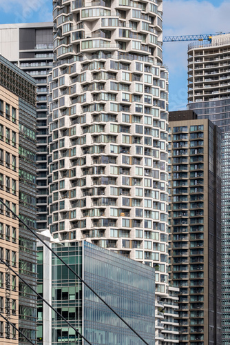 Apartment facade in London rise against the urban skyline, reflecting the city's dynamic mix of architecture. These residential buildings showcase modern living in a bustling metropolis, blending sty photo