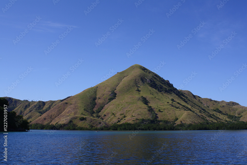 From the island in East Nusa Tenggara, Indonesia, the sweeping view of the blue ocean meets the horizon, with lush, green landscapes and untouched beaches adding to the charm. From the island in East Nusa Tenggara, Indonesia, the sweeping view of the blue ocean meets the horizon, with lush, green landscapes and untouched beaches adding to the charm.