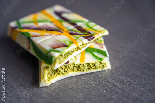 Trend Dubai white chocolate with pistachio paste and kataifi dough. Confectionery handmade sweets at home in the kitchen.  photo