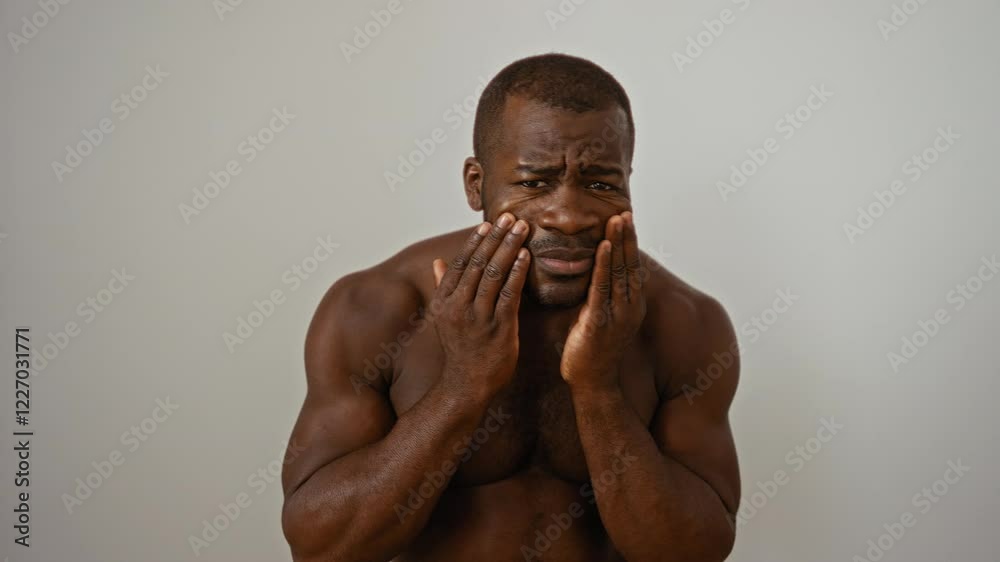 Handsome young man over an isolated white background looking concerned and applying skincare product