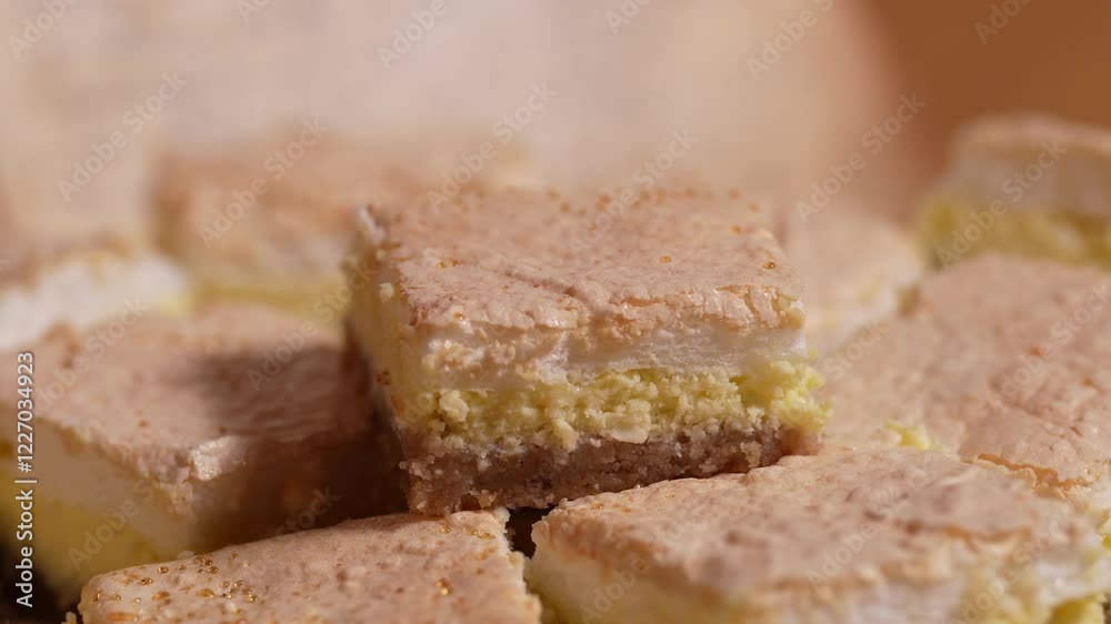 Mouthwatering close-up of a layered dessert featuring a fluffy top, creamy middle, and crumbly base, perfect for any occasion.