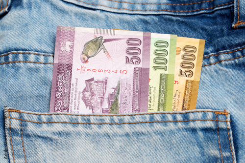 Sri Lankan  rupee in the pocket of blue jeans photo