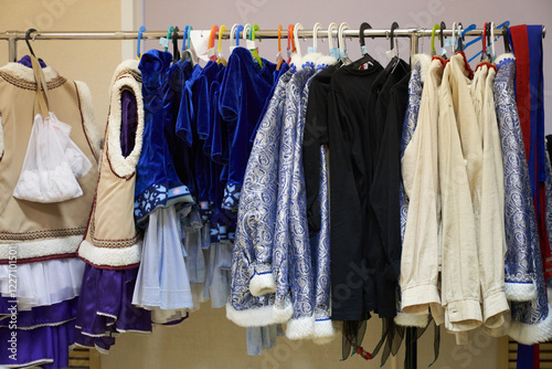 A costume rack in the theater. A fashionable dressing room behind the scenes with clothes for performances. Demonstration of beautiful clothes. High quality photo