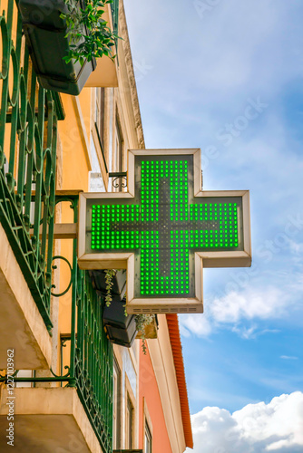 Green Cross Sign Pharmacy. Sign of pharmacy on facade of building in Europe