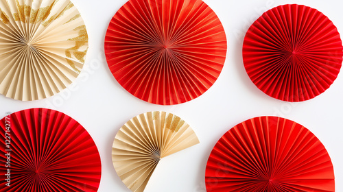 minimalist still life of red and gold decorative paper fans, artistically arranged on a pure white background.