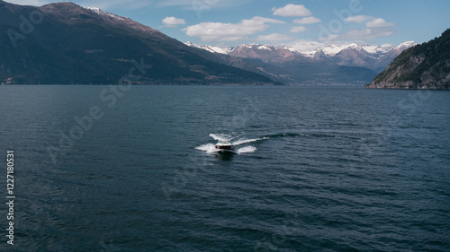 Aerial view of boat trip near Bellano, panoramic view from the drone to the famous old Italy town of Como lake. Near Varenna and Lierna, Bellano is a small town in Como, near Lecco, in Lombardia. photo