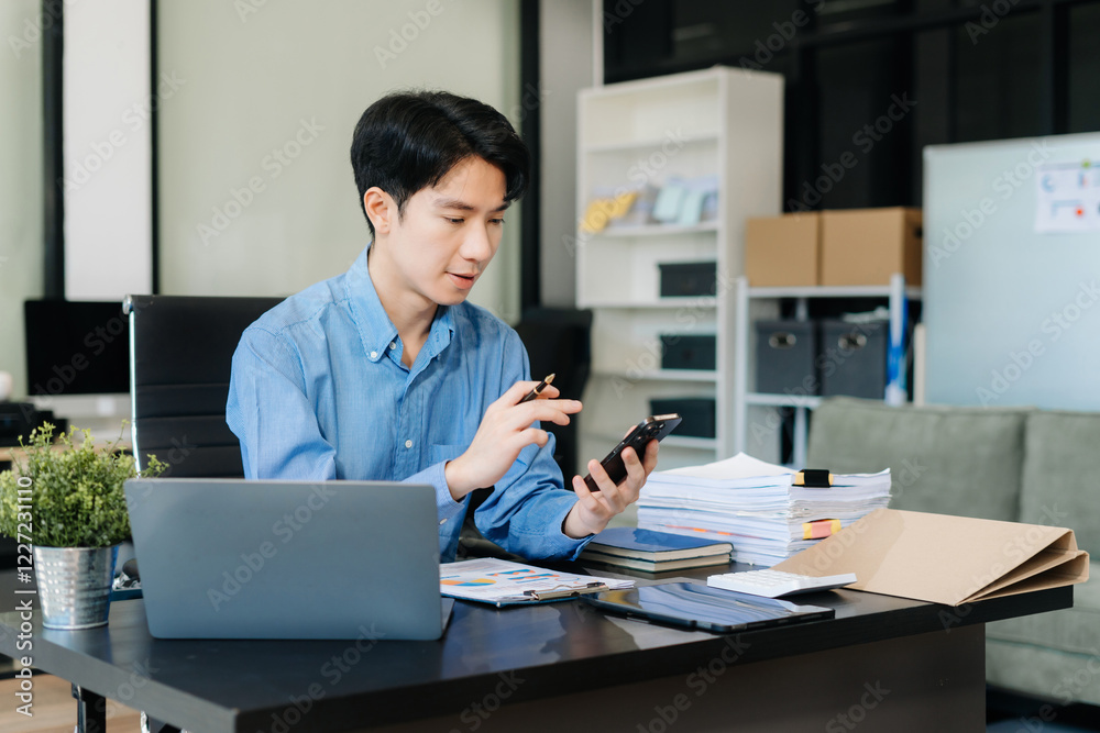 Businessman using mobile phone play social in office. Businessman using mobile phone play social in office.