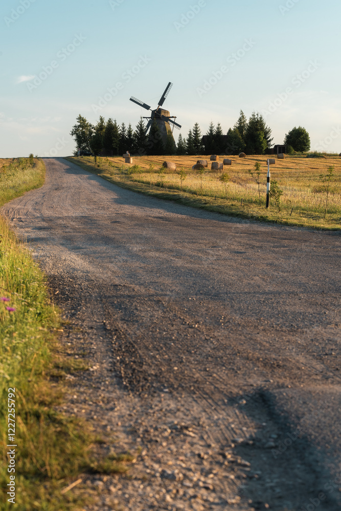 Fototapeta premium Wooden Windmill on Hillside in Autumn Rural Belarusian Landscape