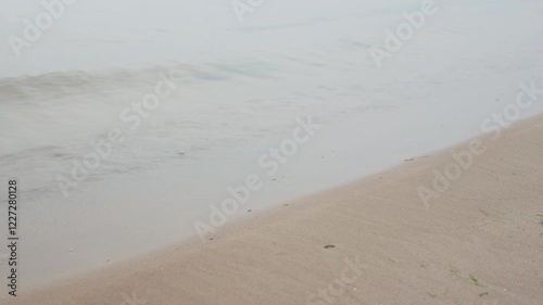 Calm waves gently washing a sandy beach of the baltic sea in Estonia