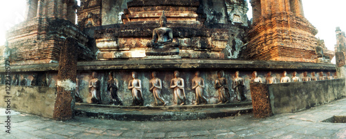Panoramic view of statues carved on the old wall of ruined temple, Sukhothai Historical Park, Sukhothai, Thailand.