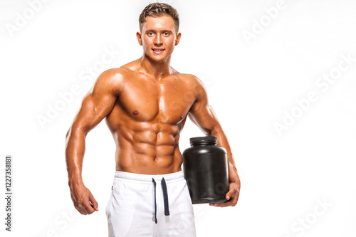 Young Muscular Man Holding Protein Supplement Container 