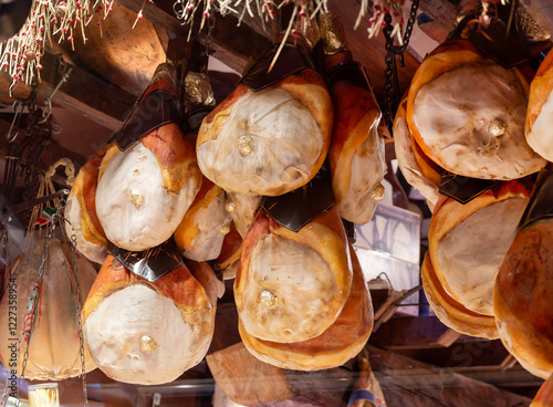 Bilde på lerret Typical Italian cured ham . Prosciutto hanging in a store
