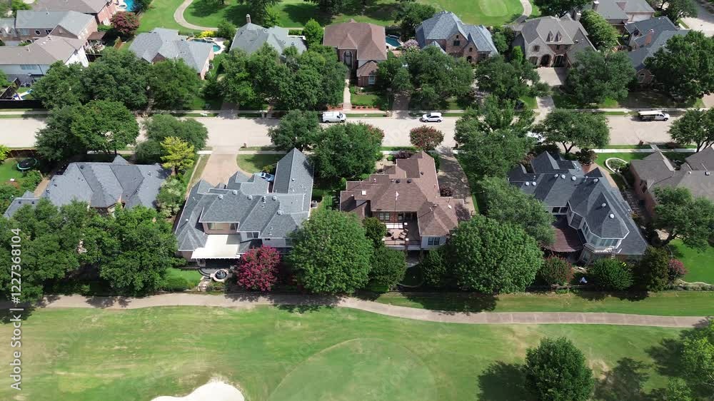 Luxury residential mansion houses concrete tiles roof, swimming pool along club car concrete pathway at upscale golf course community in East of Plano, Texas, Dallas Fort Worth metroplex, flyover