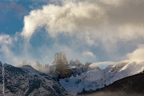 Beautiful snowy high mountain landscape with the Naranjo de Bulnes or Picu Urrielu among the mists of dawn, in the surroundings of the Picos de Europa in Asturias, Spain photo